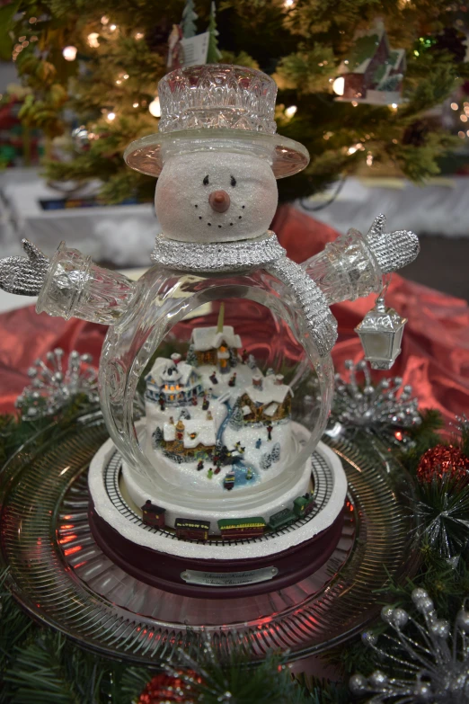 a snowman sculpture is in a christmas display