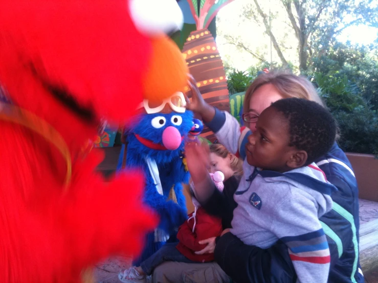 a woman petting a  next to a stuffed animal