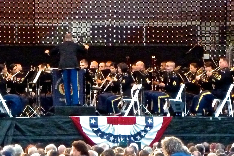 a concert with band on the stage and in front of an audience