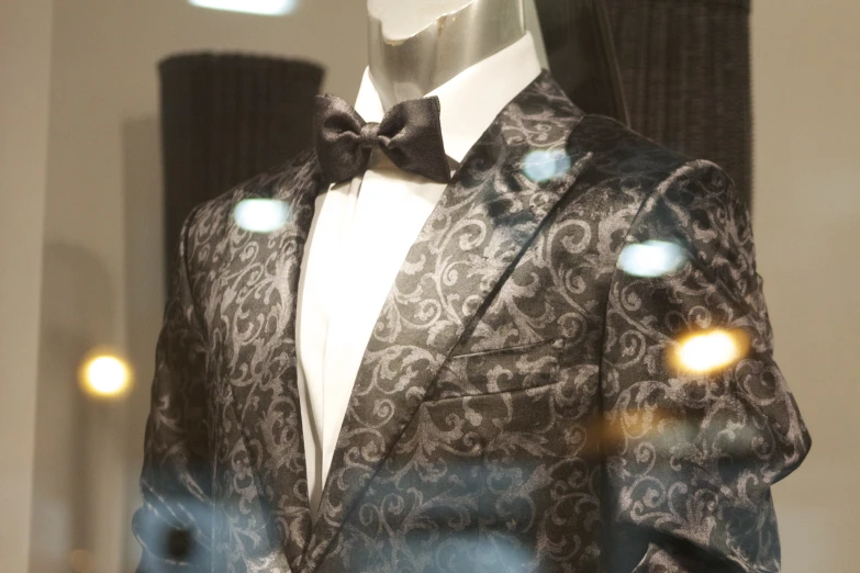 a mannequin with a black and gray suit and tie
