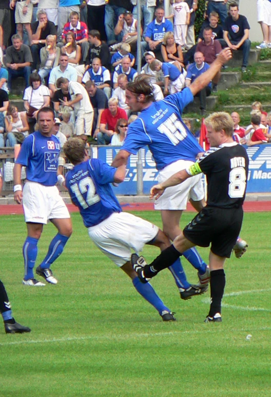 a group of men playing a game of soccer