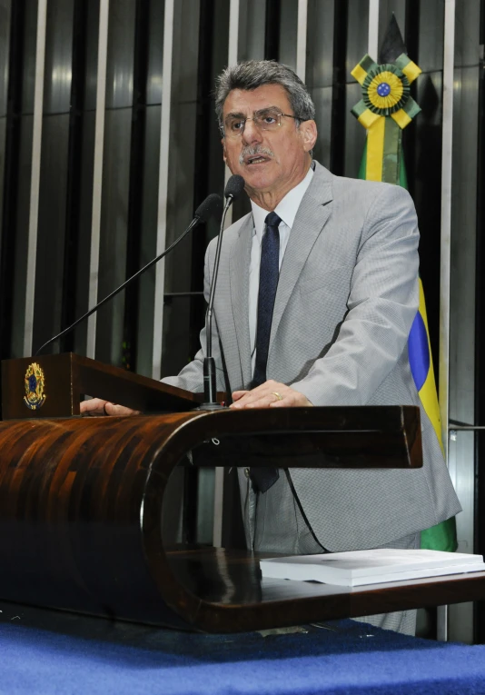 a man stands at a podium at the convention