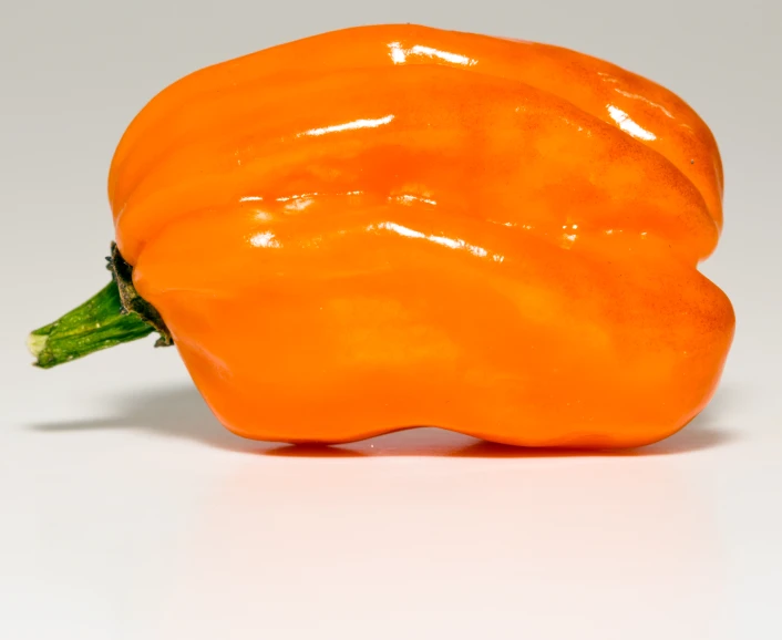 there is a giant orange pepper that is not yet cut