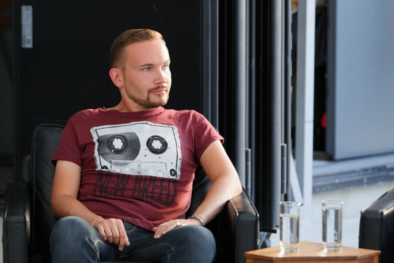 a man in a shirt with some speakers on it