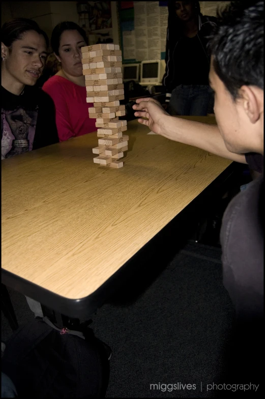 a group of people play with wooden blocks