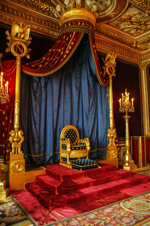 an elegant bed that has gold decor on it