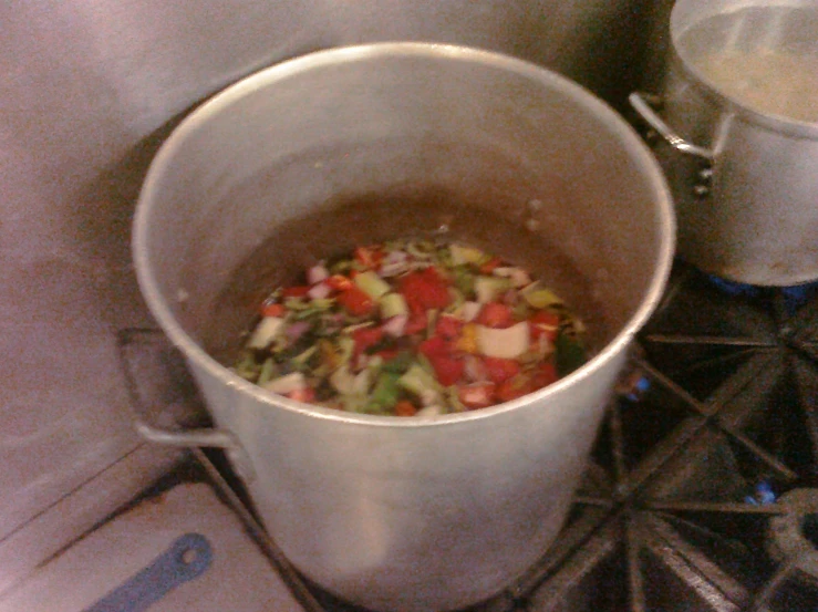 a pot sitting on top of a stove filled with food