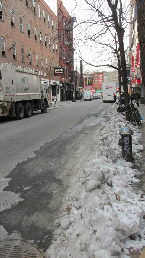 the corner of a city street is covered with snow