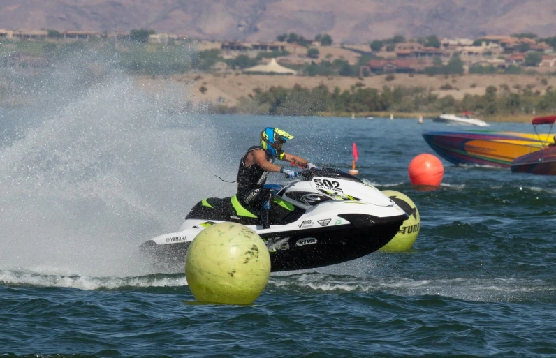 a man riding on the back of a jet ski