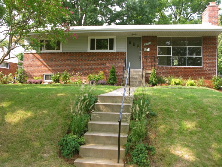 a brick house with grass and lawn on the side of it