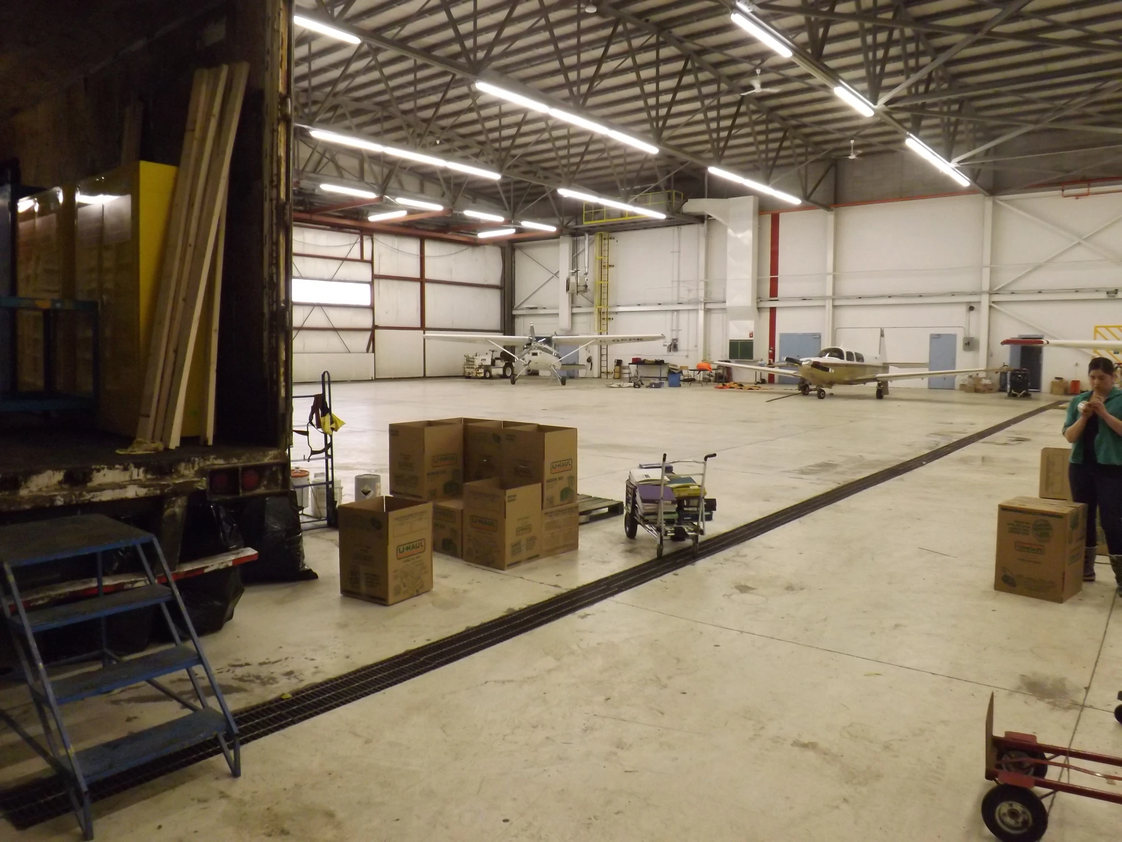 two men loading packages from a moving dolly into a warehouse