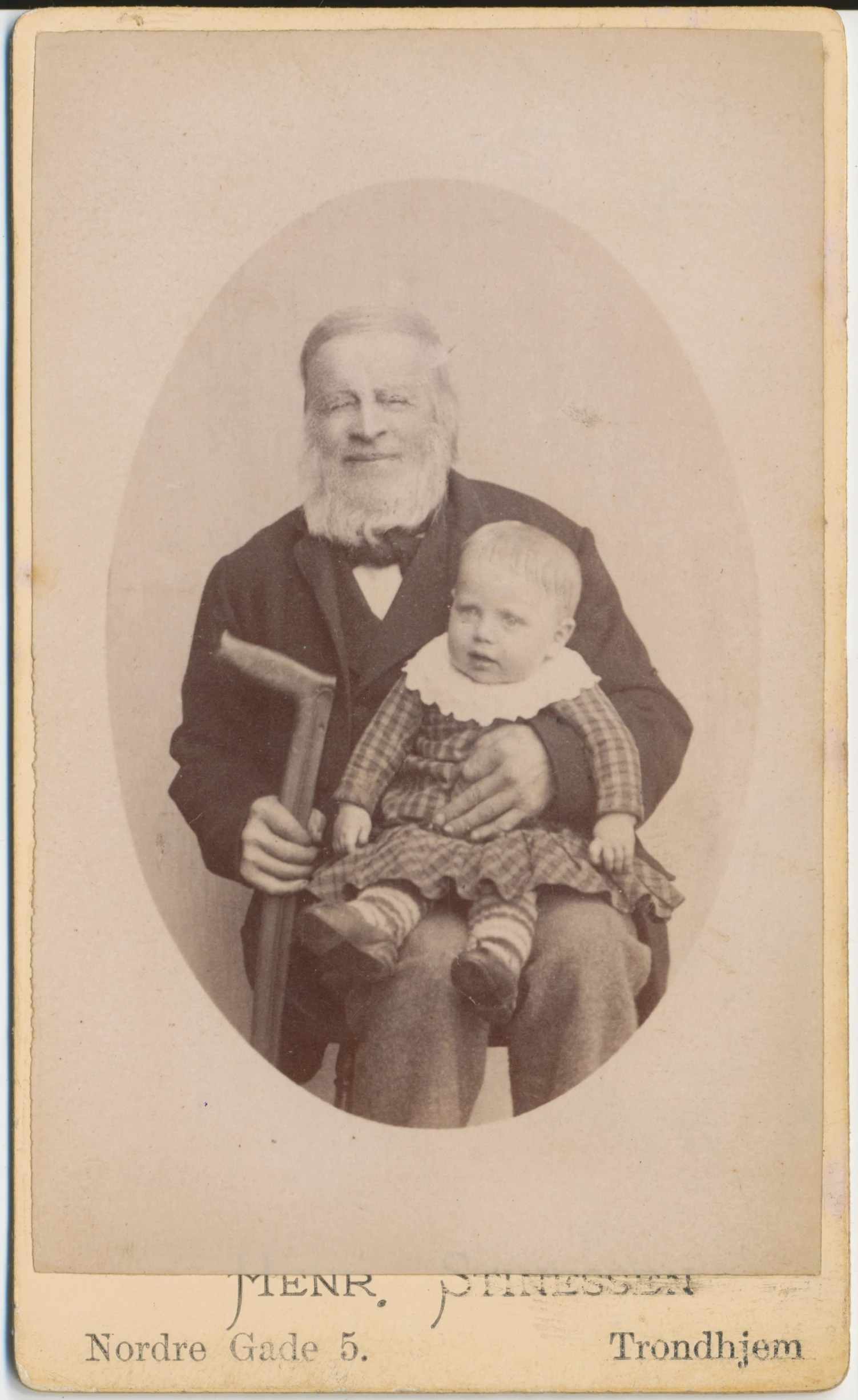 old time pograph of a man and child holding a large hammer