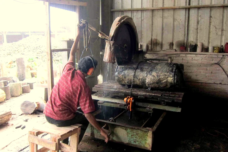 the man is making items at the machine shop