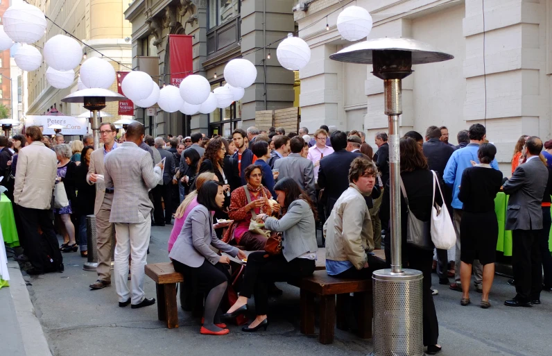 a bunch of people are gathered together on a street