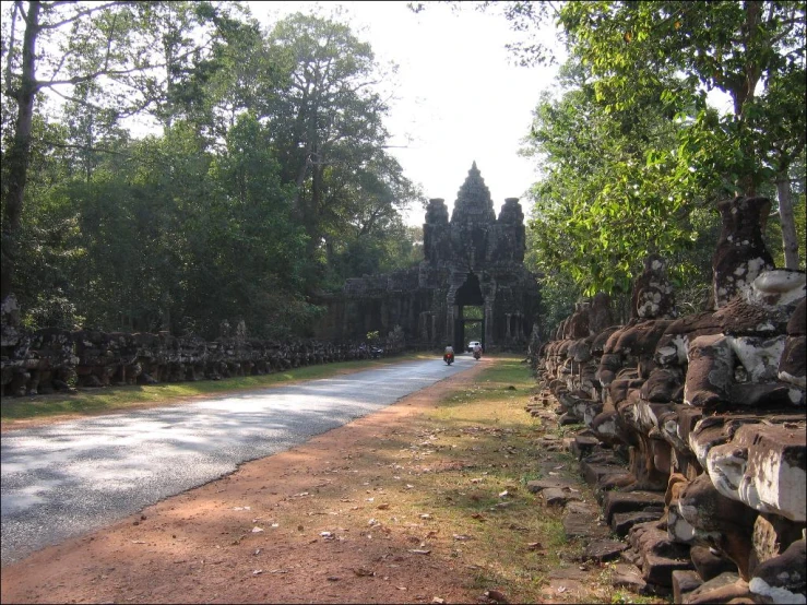 an old road in front of an ancient stone structure