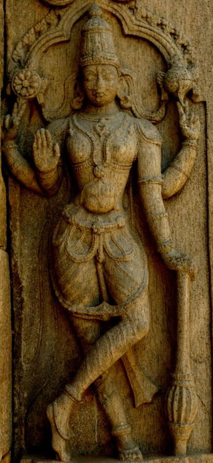 a stone relief of a male hindu figure