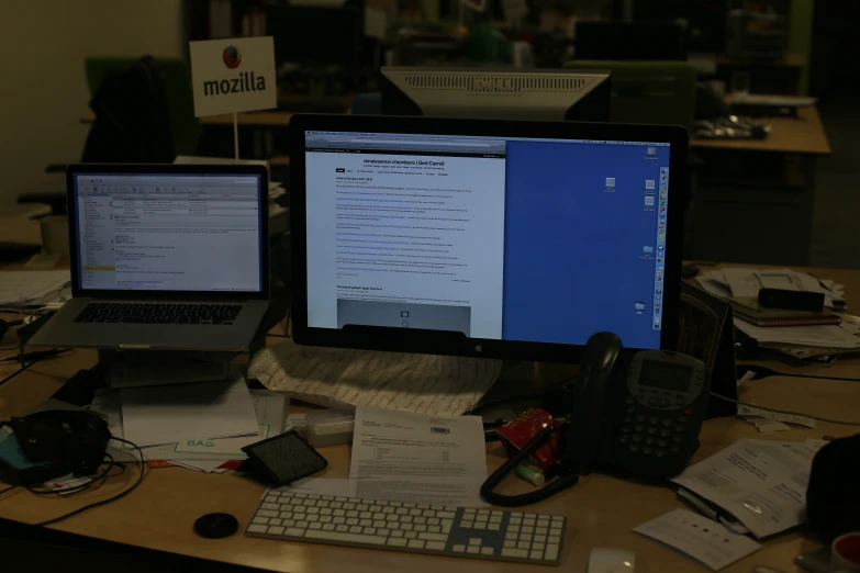 there are two laptops and several computers sitting on the desk