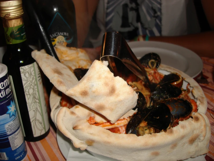 food on a plate with other plates and bottles