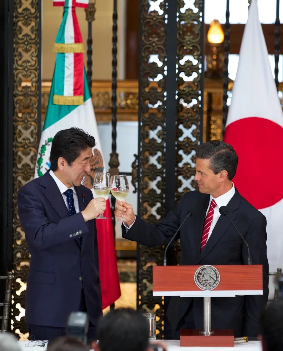 two men in suits toasting at an event