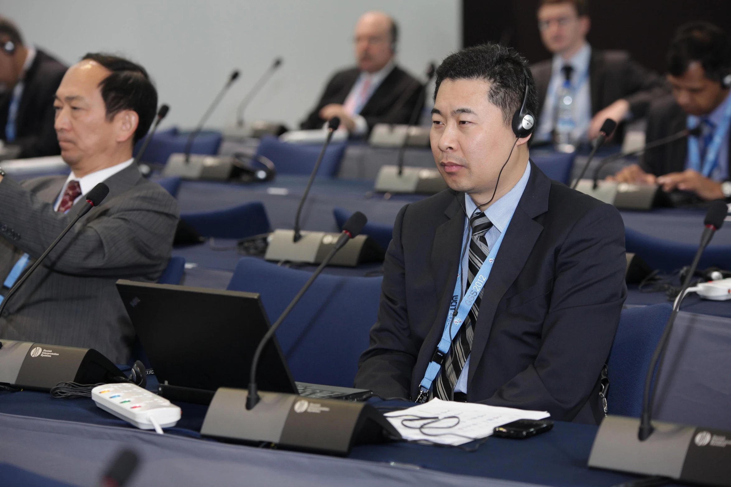 men sitting at tables using their laptops