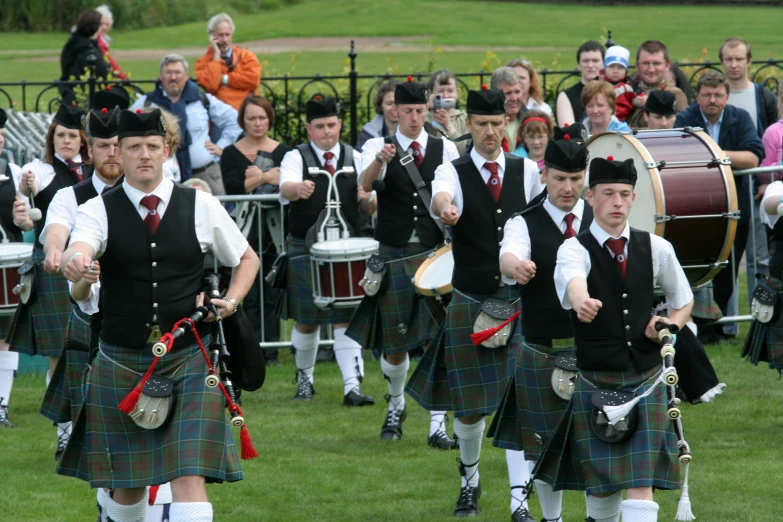 a band is marching with drum players and other musicians