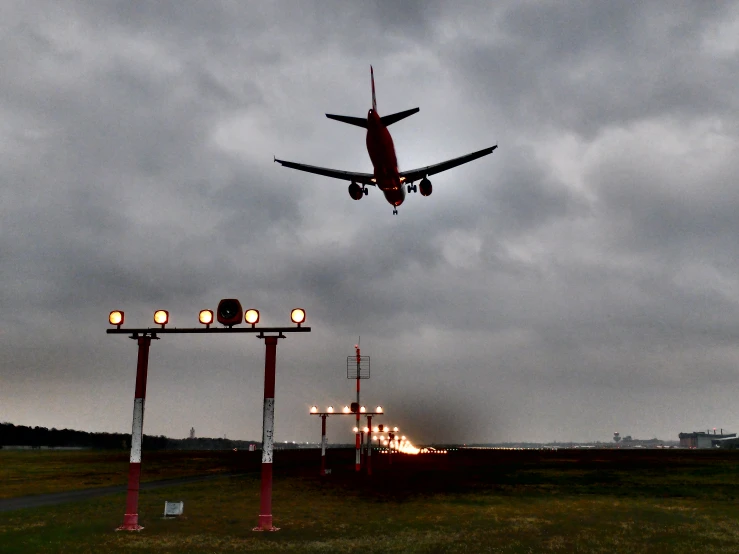 an airplane taking off over a runway with traffic lights