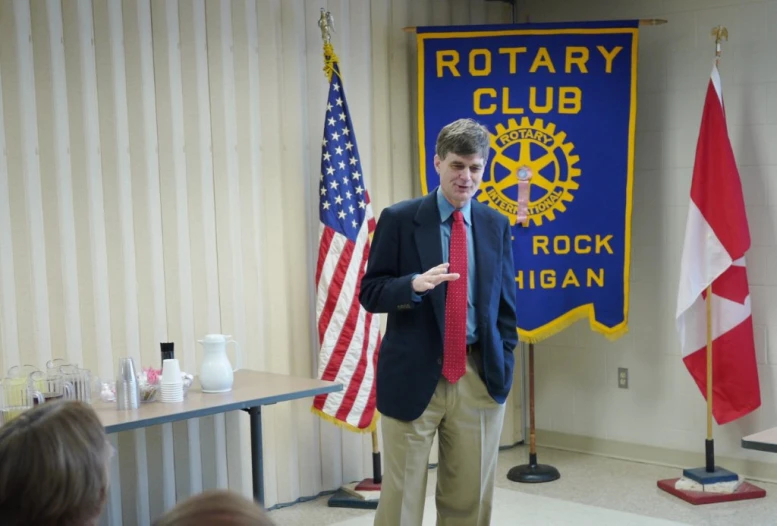 a man is holding his tie in front of him