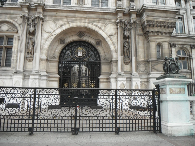 this is an old building with a gate on one side