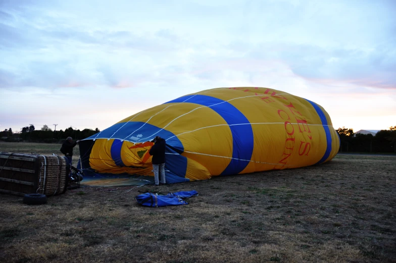 some people in a big yellow and blue object