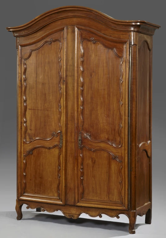 the armoire has two doors and a curved top