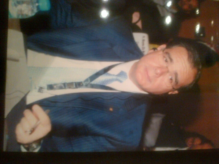 man standing in suit and tie smiling for camera