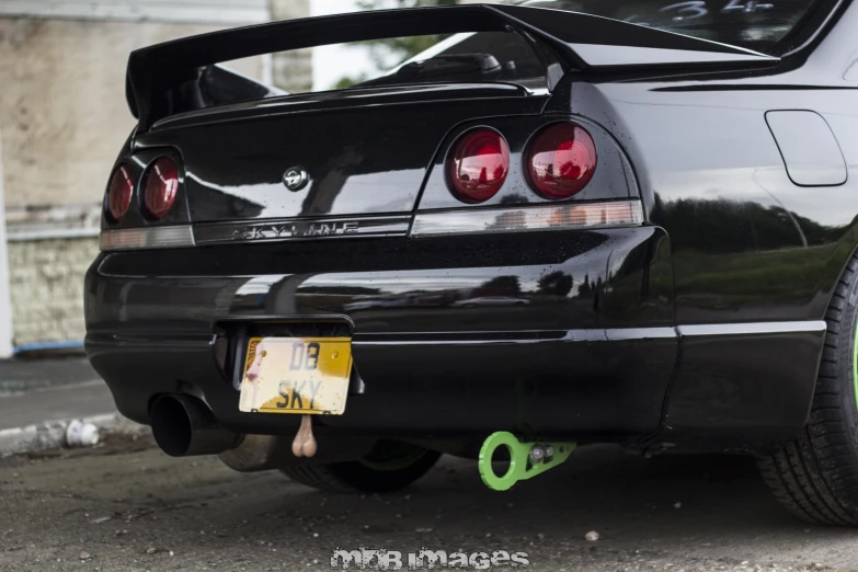 the back end of a sports car parked on the side of the road