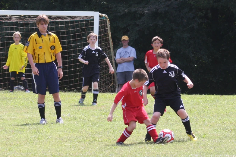 several s playing soccer on a grassy field