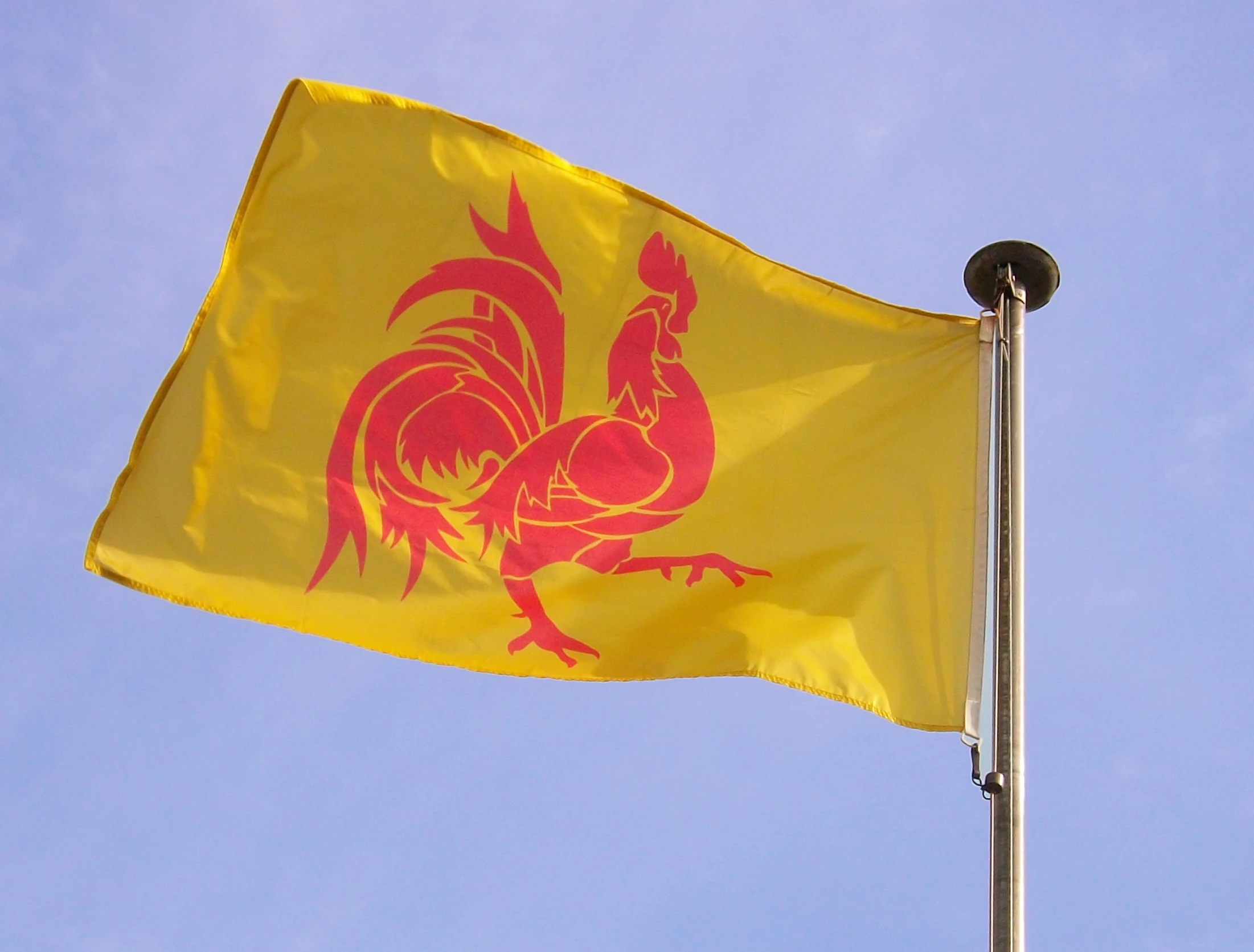 a flag is flying in the wind and clear blue sky