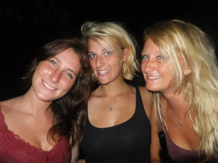 three pretty young ladies posing for a po