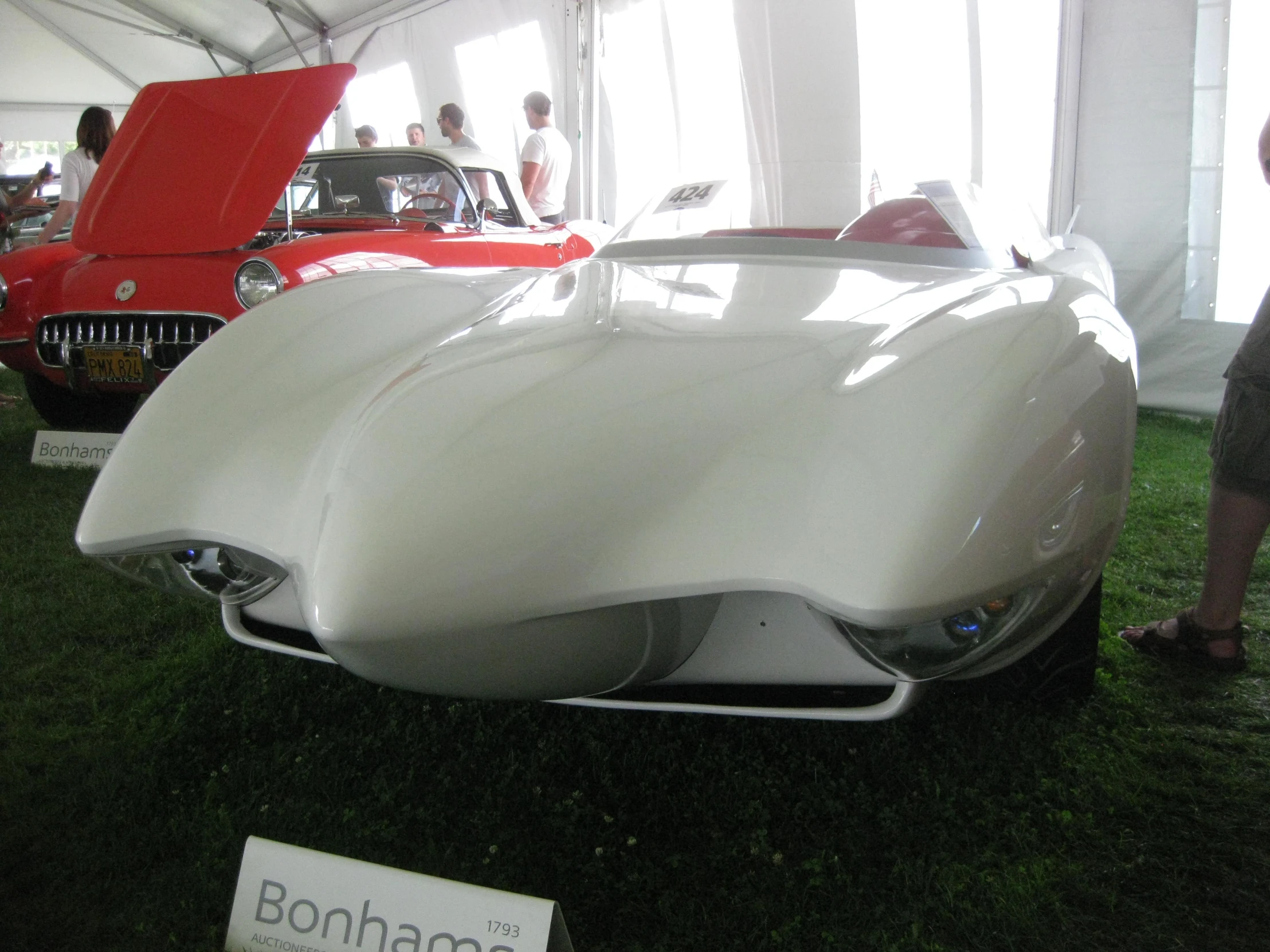 several cars in an outdoor building at a car show