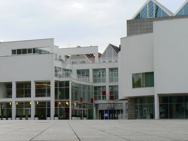 an empty courtyard in front of a building with a clock tower