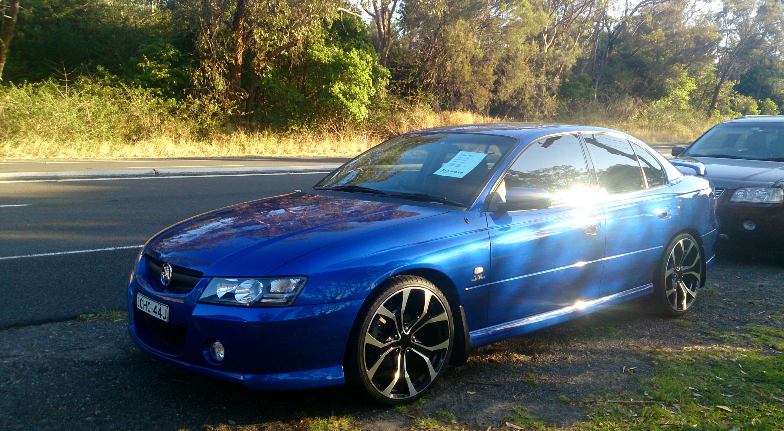 a blue car parked on the side of the road