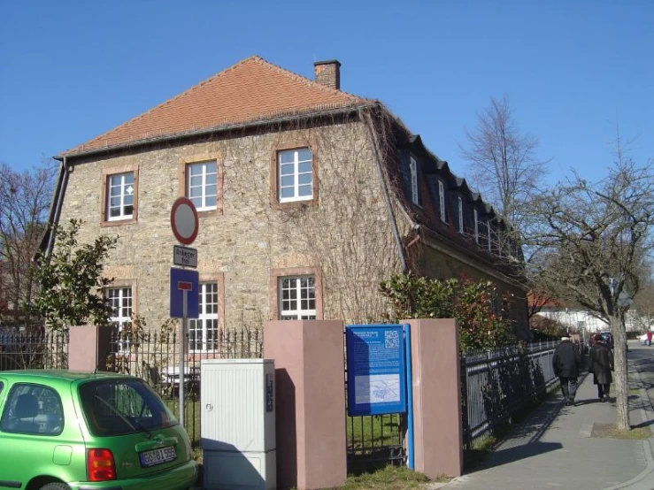 an old building near the road that is very colorful