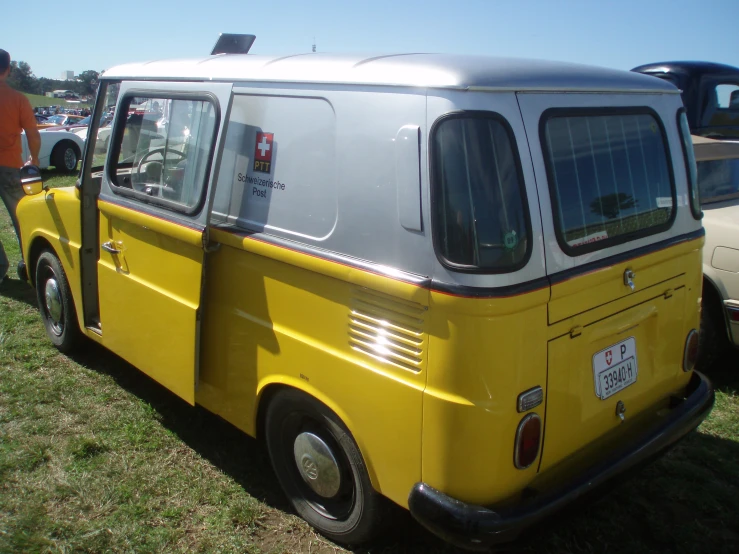 the yellow van is parked on the grass