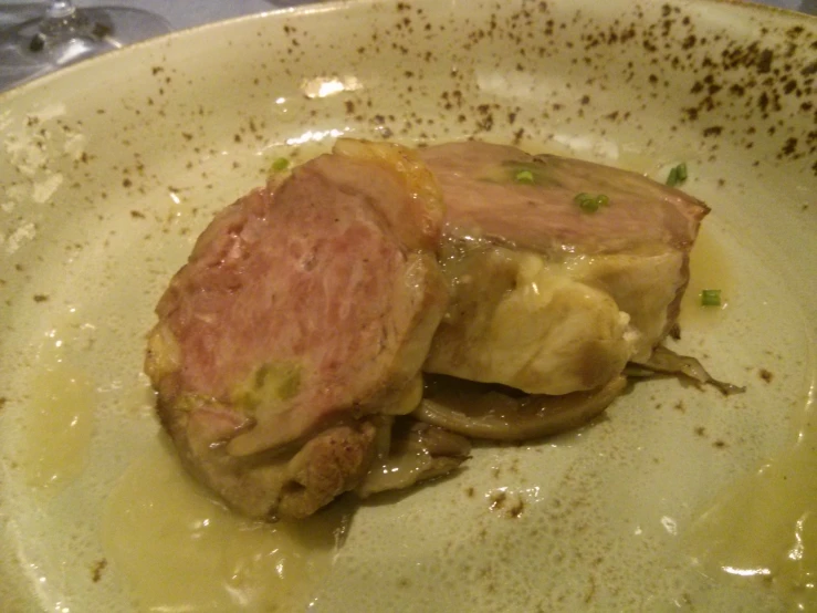 an entree sits on a dish made from white clay