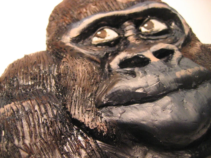 a sculpture of a gorilla is sitting and smiling