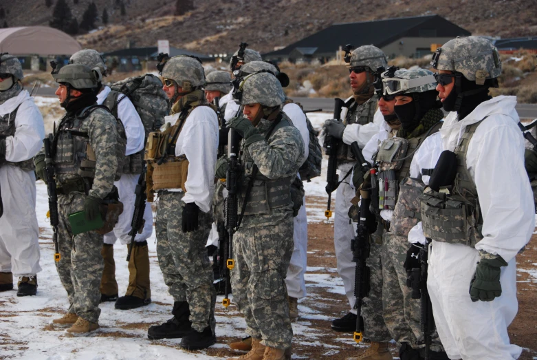 military personnel talking in formation by holding gun