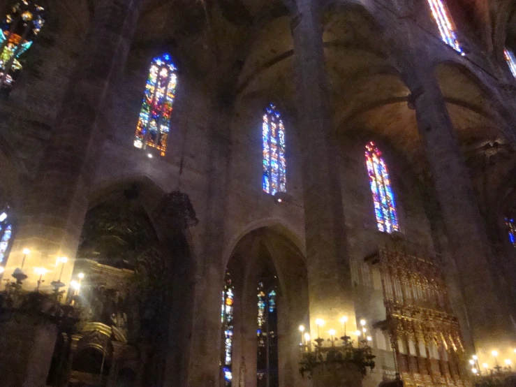 the ceiling of a large cathedral with two rows of stained glass windows