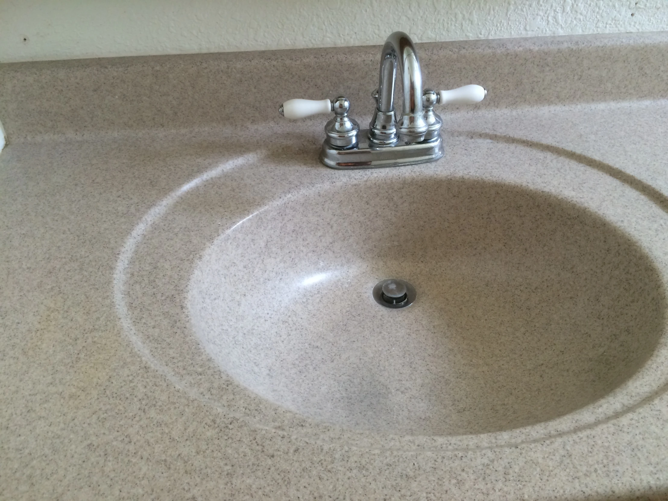 a bathroom sink with a long black faucet