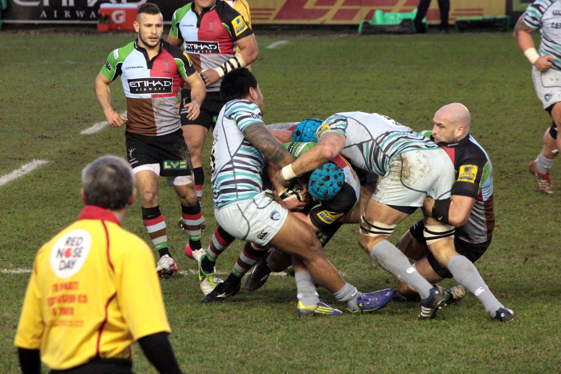 several men playing rugby on a green field