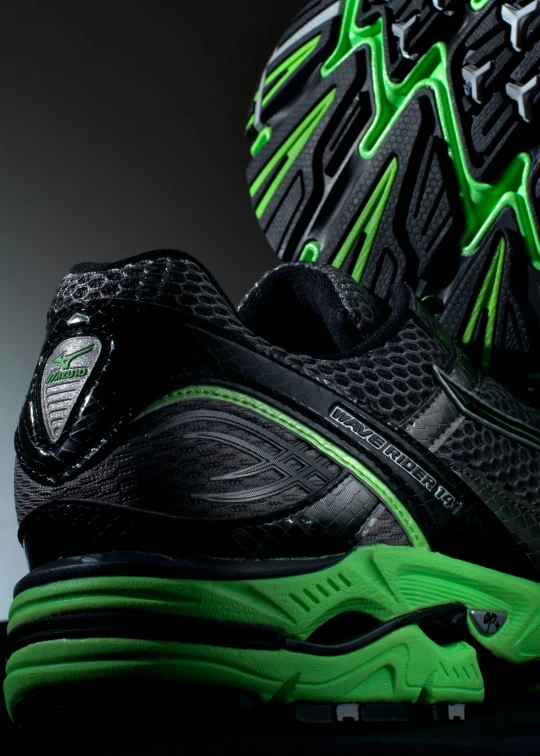 the upper part of a running shoe with green accents