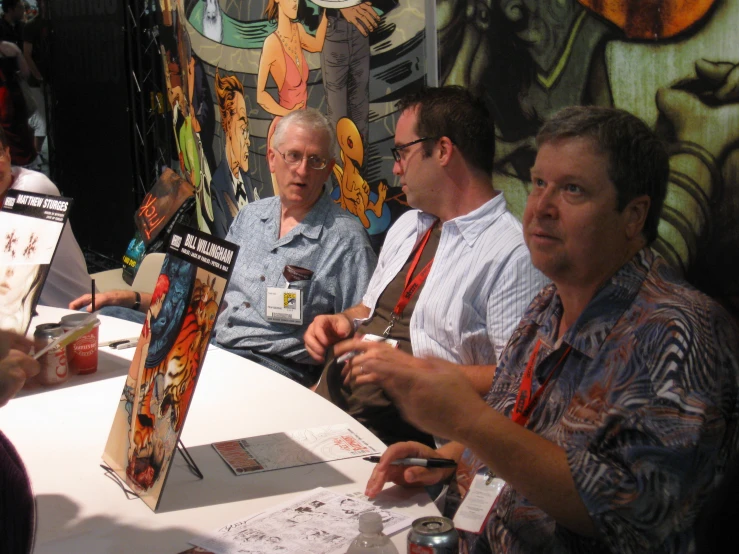 a group of people are sitting at a table