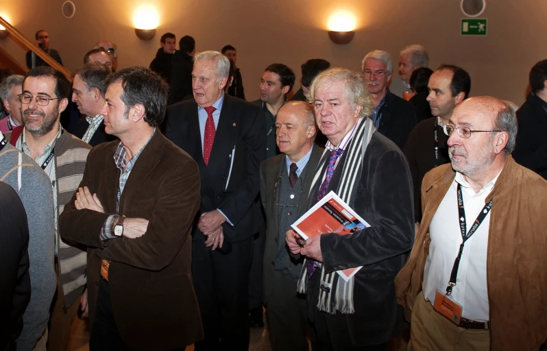 group of people standing next to each other at a meeting