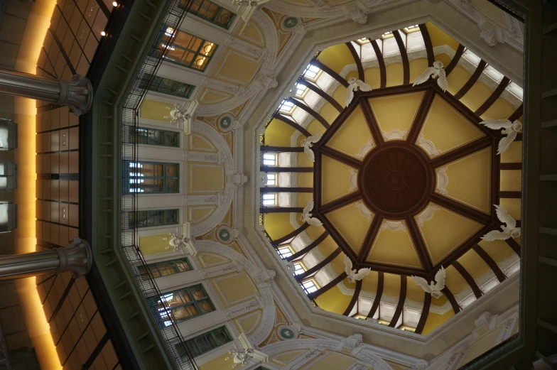 a domed ceiling above a marble floor inside of a building